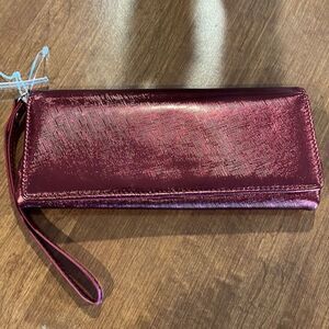 The Many Moods of Poppie Jones red metallic clutch purse with strap.